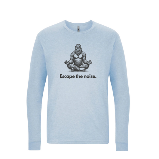 Heather Blue long-sleeve t-shirt featuring a black graphic of a meditating Sasquatch with the phrase "Escape the noise." for a playful and calming outdoor style