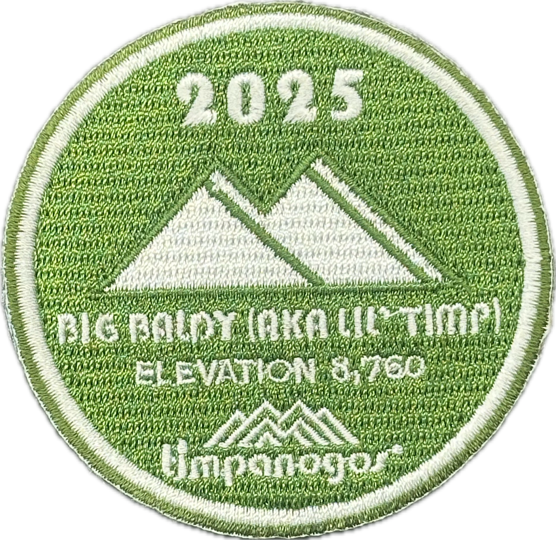 2025 Timpanogos "Big Baldy (aka Lil' Timp)" patch in green and white, featuring the mountain design with "Big Baldy (aka Lil' Timp)" at an elevation of 8,760 feet, with the Timpanogos Hiking Co. logo at the bottom.