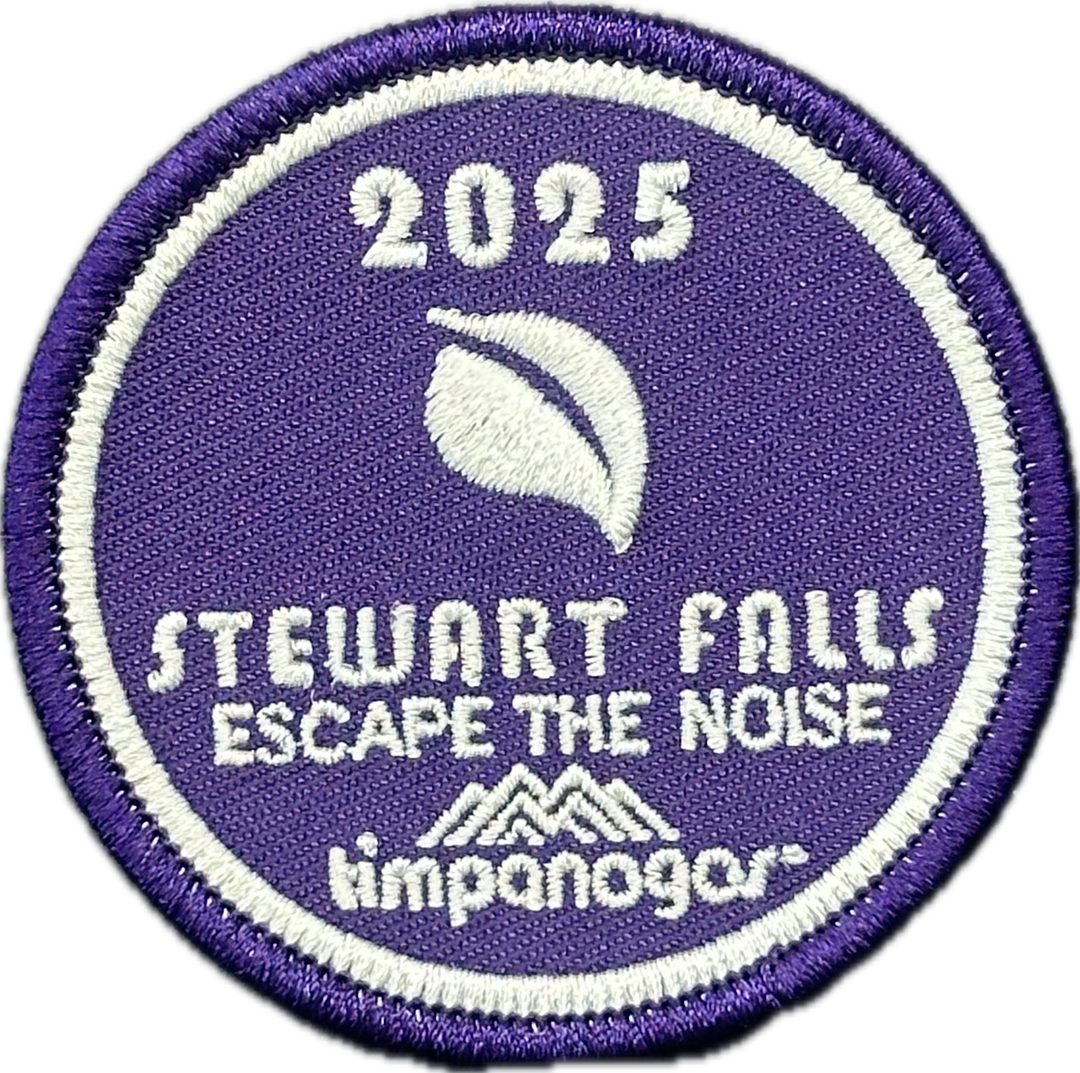2025 Timpanogos "Stewart Falls" patch in rich purple with white embroidery. Displays a minimalist leaf graphic, the phrase "Escape the Noise," and the Timpanogos Hiking Co. logo beneath.