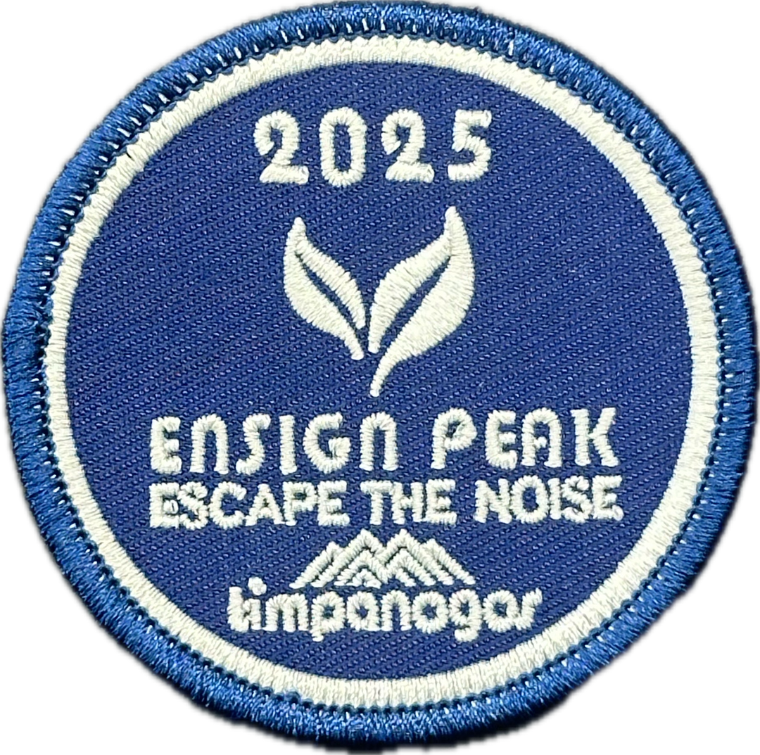 2025 Timpanogos “Ensign Peak” patch in deep blue with white embroidery. Features two stylized leaves, the phrase “Escape the Noise,” and the Timpanogos Hiking Co. logo, all framed by a clean circular border.