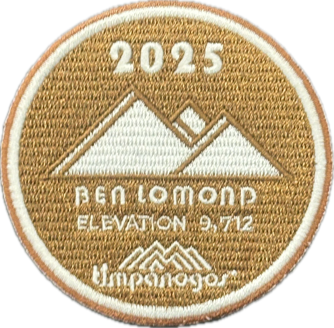 2025 Timpanogos “Ben Lomond” patch in tan with white embroidery. Features a triple peak mountain design, labeled “Ben Lomond” with an elevation of 9,712 feet, and includes the Timpanogos Hiking Co. logo below.