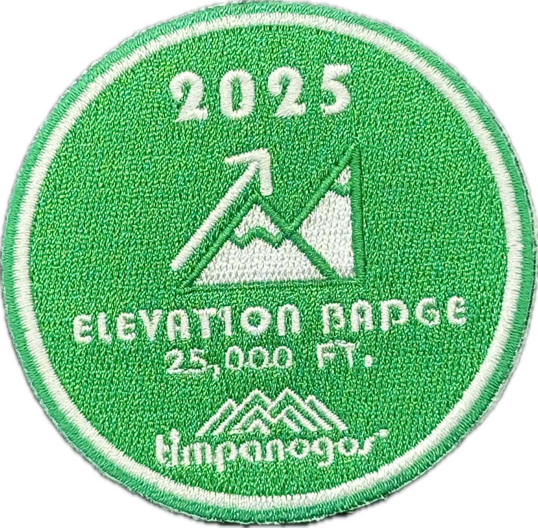 2025 Timpanogos Elevation Badge patch in bright green with white embroidery, awarded for achieving 25,000 feet of elevation gain. Features a mountain and arrow graphic with the Timpanogos Hiking Co. logo below.