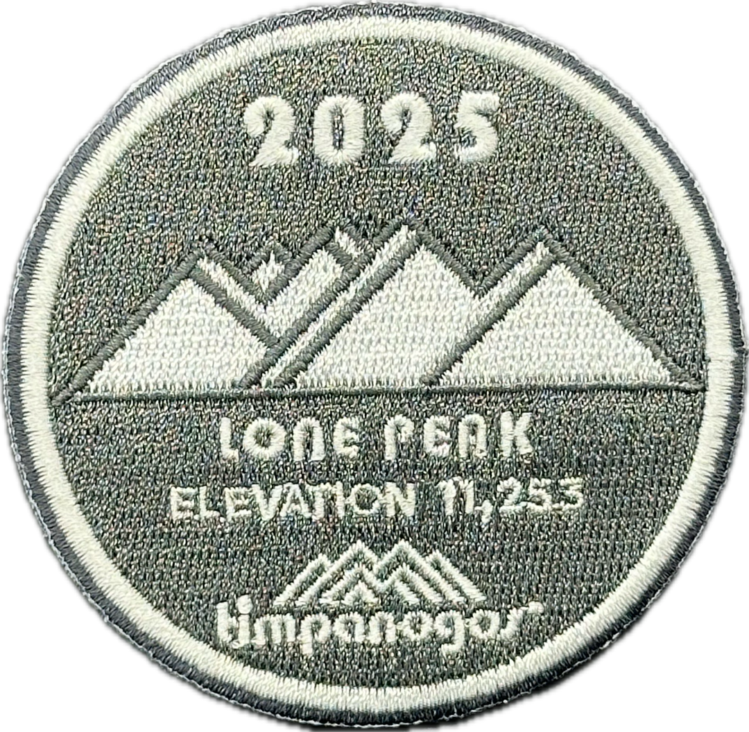 2025 Timpanogos "Lone Peak" patch in gray and white with the mountain design. It features the peak labeled "Lone Peak" at an elevation of 11,253 feet, with the Timpanogos Hiking Co. logo below.