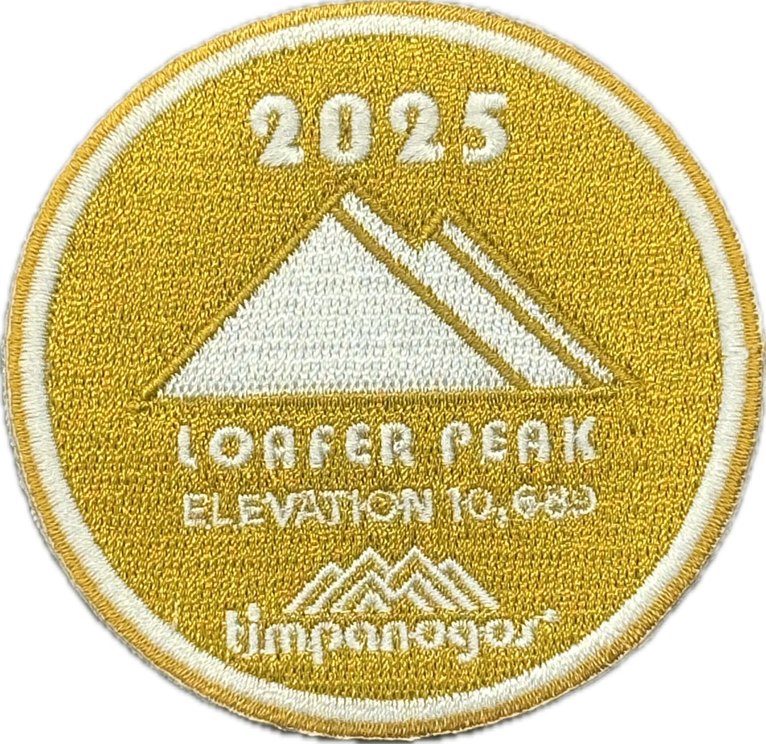 2025 Timpanogos “Loafer Peak” patch in gold with white embroidery. Features a mountain design with the peak labeled “Loafer Peak” at an elevation of 10,663 feet, and includes the Timpanogos Hiking Co. logo beneath.