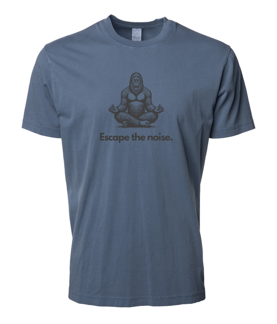 Slate Blue “Escape the Noise” t-shirt by Timpanogos Hiking Co., featuring a meditating Bigfoot graphic — unisex outdoor tee for those who seek peace, solitude, and a little mystery.