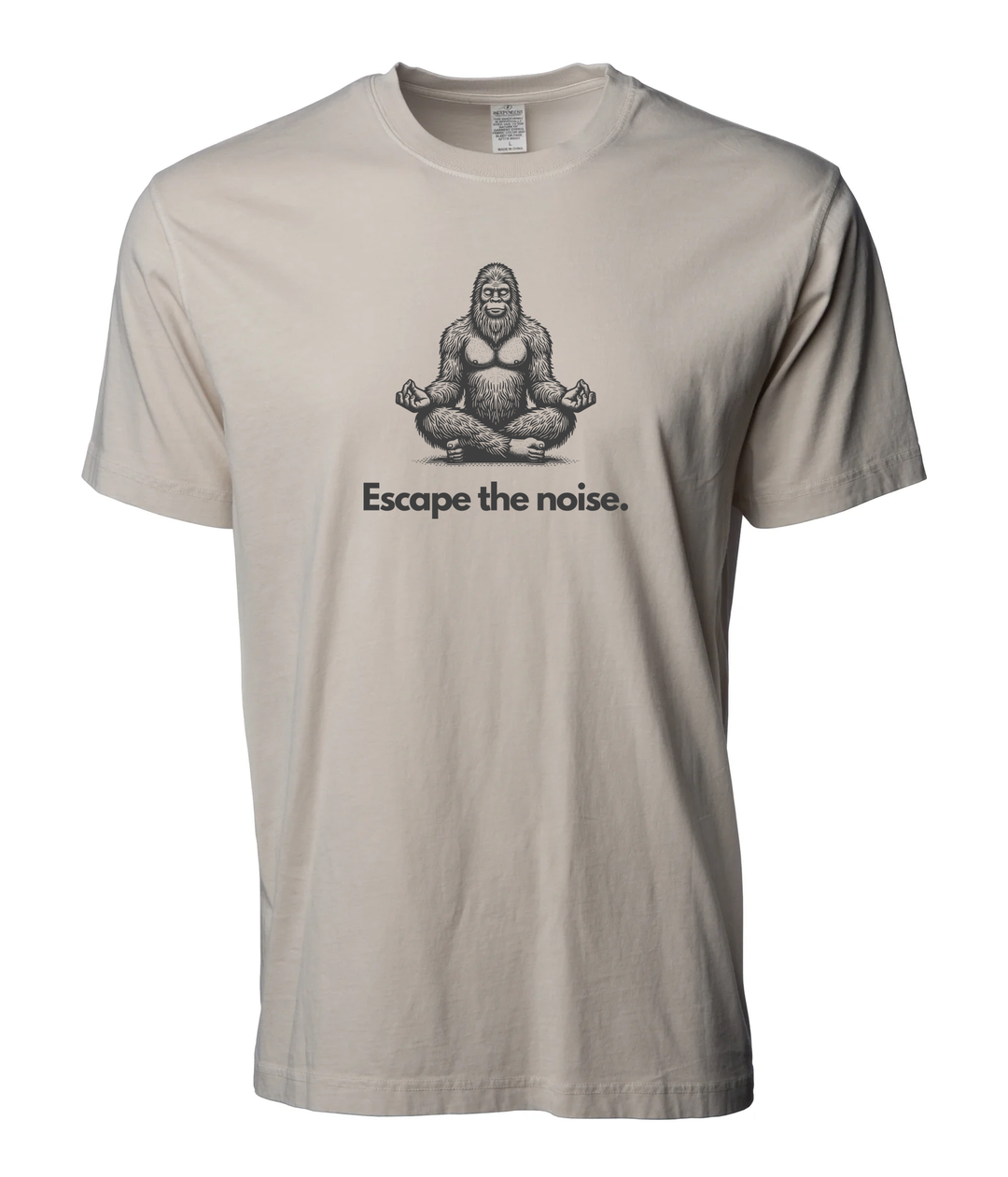 Natural cream “Escape the Noise” t-shirt by Timpanogos Hiking Co., featuring a meditating Bigfoot graphic — unisex outdoor tee for those who seek peace, solitude, and a little mystery.