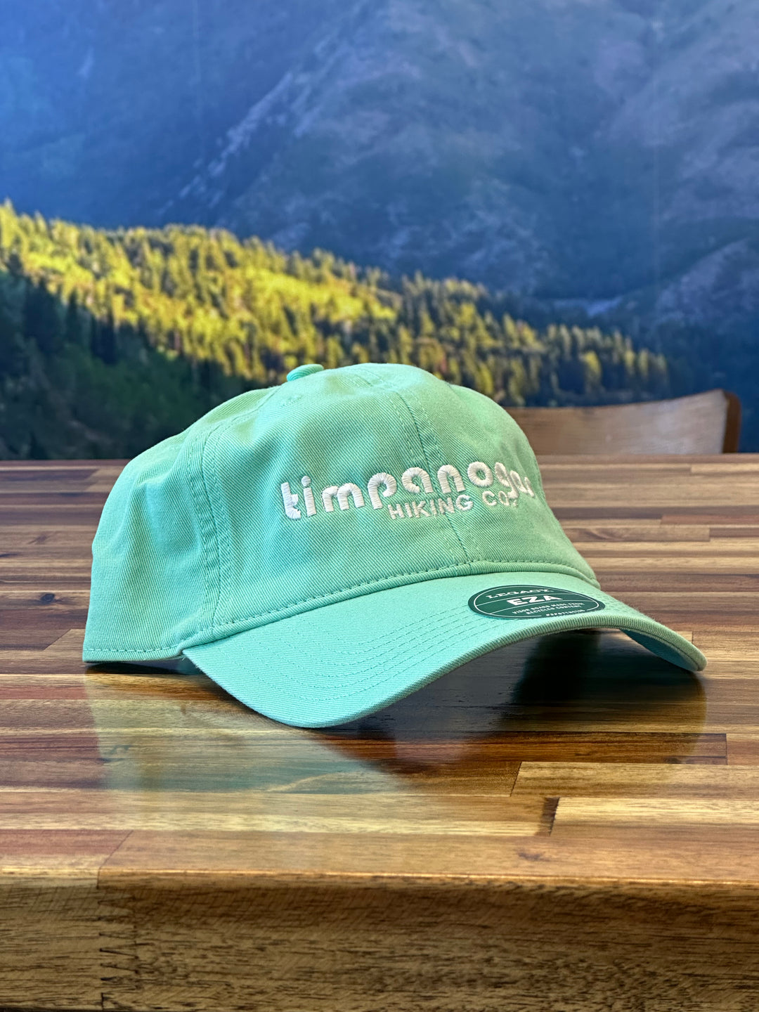 Casual light green hat featuring the Timpanogos Hiking Co. logo embroidered in white, perfect for keeping the sun out of your eyes on your next hiking trip

