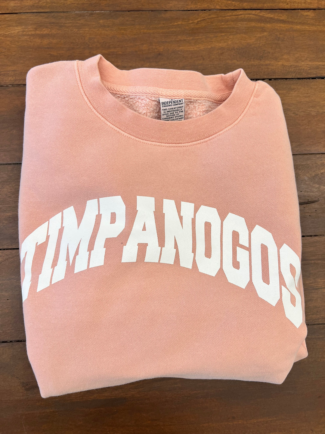 Light pink sweatshirt featuring the bold white "TIMPANOGOS" logo across the front, designed for those who love outdoor adventures and want to rep the Timpanogos spirit

