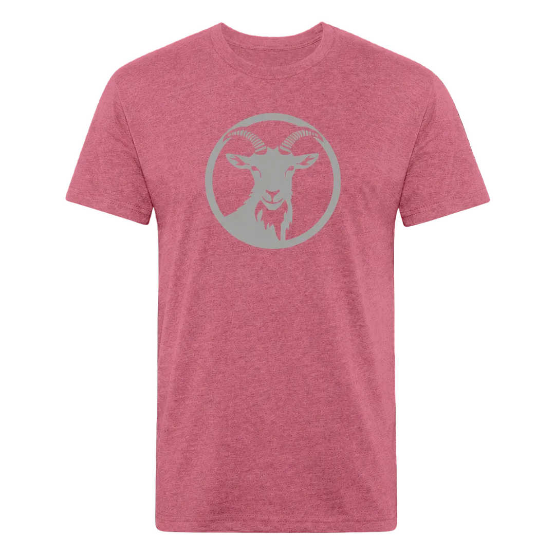 A heather pink crewneck t-shirt featuring a light gray circular graphic of a goat head on the chest, displayed against a solid black background.